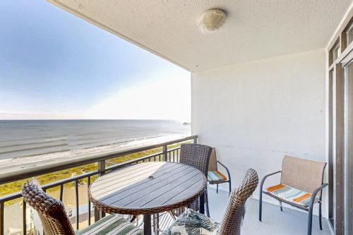 a balcony with a table and chairs and the ocean at Beachwalk Villas 504 in Myrtle Beach