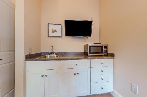 a kitchen with a microwave and a sink at A1 at Castle Hill - Apartment in Cavendish