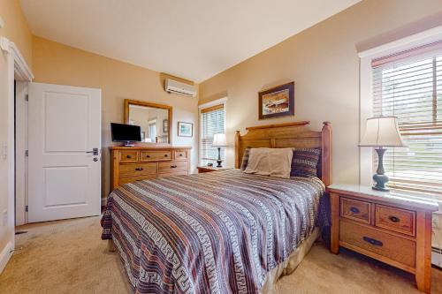 a bedroom with a bed and a dresser and a television at A1 at Castle Hill - Apartment in Cavendish