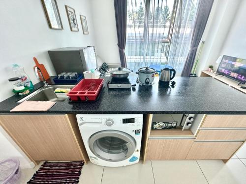 a kitchen with a washing machine and a sink at SA Sutera Avenue Homestay Kota Kinabalu Area KK City Opposite Imago in Kota Kinabalu