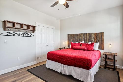 a bedroom with a red bed with a red blanket at Stylish Virginia City Apartment with Deck! in Virginia City