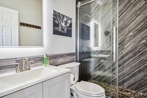 a bathroom with a toilet and a sink and a shower at Stylish Virginia City Apartment with Deck! in Virginia City