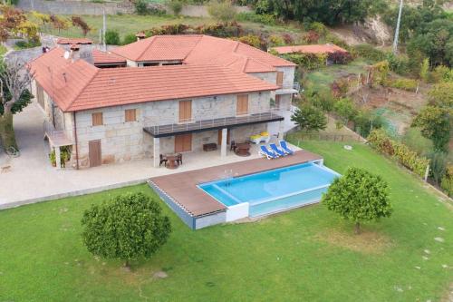an aerial view of a house with a swimming pool at O Palheiro da Anastácia in Marco de Canaveses