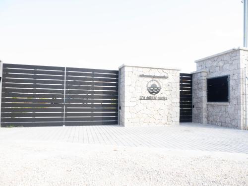 una porta nera del garage con un cartello sopra di Sea breeze suites Maistro 4per with private pool a Candia