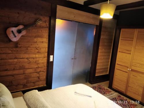a bedroom with a guitar hanging on a wall at CASTEL RESIDENCE in Braşov