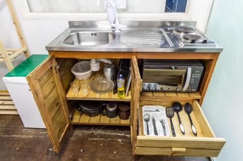 a kitchen counter with a sink and a drawer at Praia Camburi - Studios Kuta in Camburi