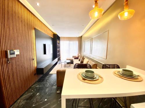 a living room with a table and chairs at NEW modern 1 BR, 1min fr tramway in Casablanca