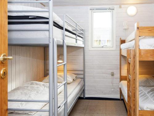 a bunk room with bunk beds and a window at Three-Bedroom Holiday home in Lemvig 1 in Lemvig