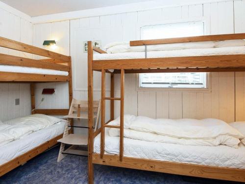 a room with two bunk beds and a window at Three-Bedroom Holiday home in Lemvig 6 in Lemvig