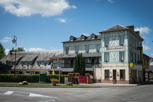 a large blue and white building on a street at Logis L'auberge Du President in Cormeilles