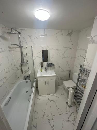 a bathroom with a tub and a sink and a toilet at Studio Room In Brighton in Brighton & Hove