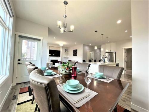 a dining room and kitchen with a table and chairs at Luxury Retreat For Large Groups in Calgary