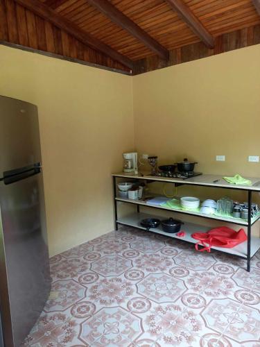 a kitchen with a shelf with food on it at Surf Shack Room #2 in Pavones