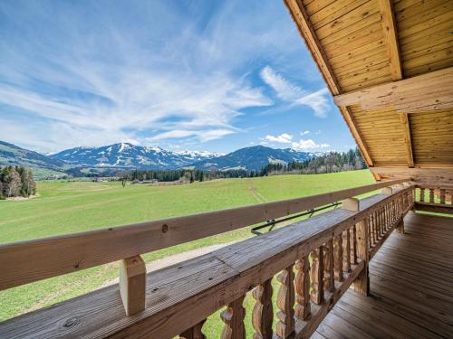 a porch of a cabin with a view of the mountains at Flicklhof XL in Penning