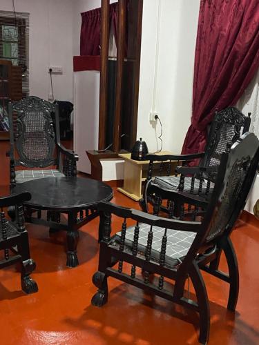een kamer met 2 stoelen en een tafel bij Rani Villa Beach Guest House Trincomalee in Trincomalee