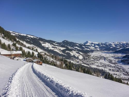 a snow covered mountain with a road in the snow at Troadstadl Windaublick in Westendorf