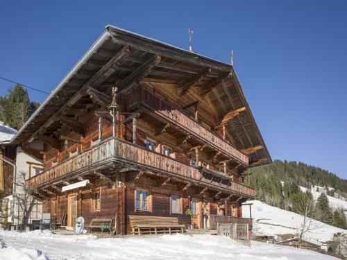 a large log cabin in the snow at Troadstadl Windaublick in Westendorf