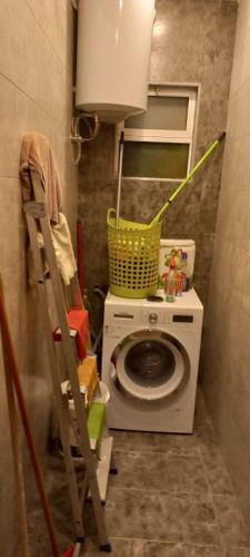 a laundry room with a washing machine and a washer at جبل عمان الدوار الخامس in Amman