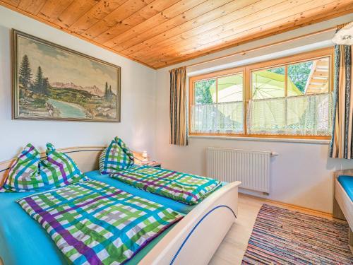 a bedroom with a bed and a window at Schergrub in Kirchberg in Tirol