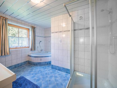 a bathroom with a shower and a tub at Schergrub in Kirchberg in Tirol