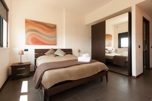 En eller flere senger på et rom på Della Piana Residence