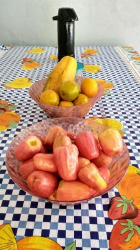two baskets of fruits and vegetables on a table at Pousada Chacara Cururu in Alter do Chao