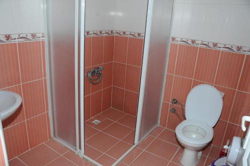 a bathroom with a shower with a toilet and a sink at Hotel Dort Mevsim in Pamukkale