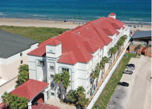 an aerial view of a building with red roofs and the beach at Sand Rose Beach Resort in South Padre Island