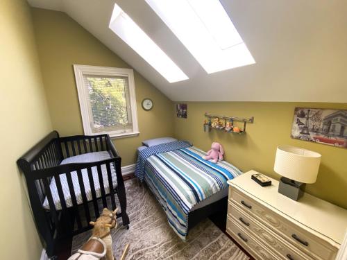 a childs bedroom with a bed and a window at iResidence in Toronto - Unique Mansion - Fantastic Views with Breakfast in Toronto