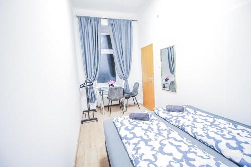 a bedroom with a bed and a chair and a window at Modern Double room HN in Vienna