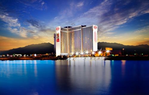 a view of a hotel at night with the water at Grand Sierra Resort and Casino in Reno