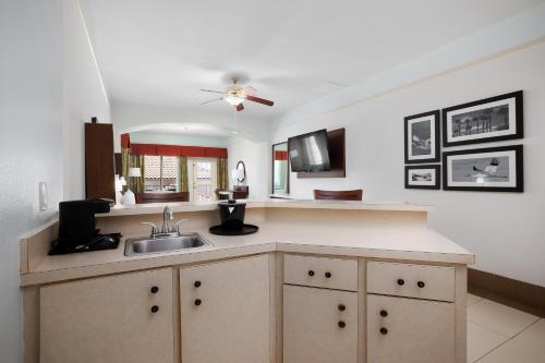a kitchen with a sink and a ceiling fan at Sand Rose Beach Resort in South Padre Island