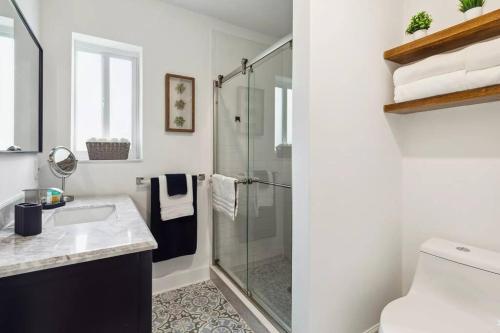 a bathroom with a shower and a sink at Cozy Design District Spacious Home in Miami