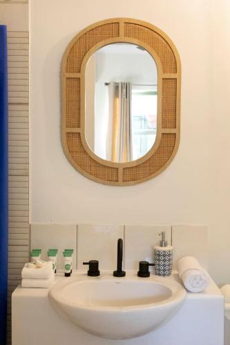 a bathroom with a sink and a mirror at Where Enchanted Garden meets Tropical Paradise in Darwin