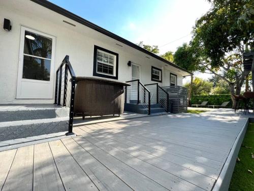 a house with a wooden deck in front of it at Stylish 3/2 centrally located! in Miami