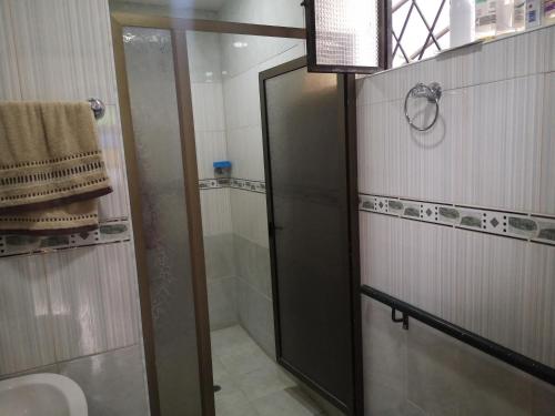 a bathroom with a shower and a glass door at Chachagüi in Pasto