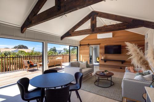 a living room with a couch and a table at Onetangi Beach Stays Apartment - Coast & Country in Onetangi