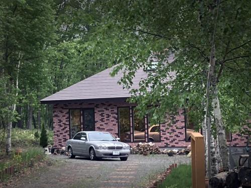 a car parked in front of a brick house at Hororo Style in Shimo-setsuri