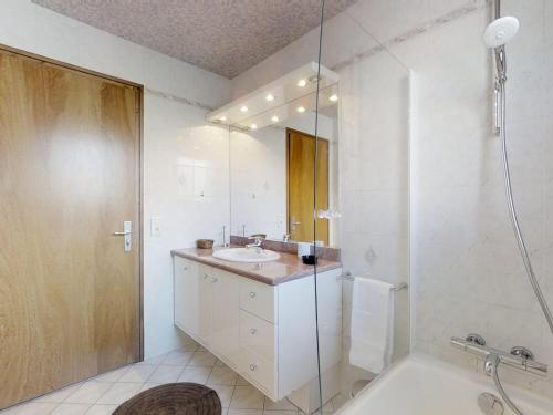 a white bathroom with a sink and a shower at Appartement Le Grand-Bornand, 3 pièces, 4 personnes - FR-1-467-55 in Le Grand-Bornand
