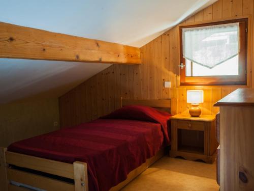 - une chambre avec un lit rouge et une fenêtre dans l'établissement Confortable 4 chambres, balcon, proche télécabines - FR-1-467-67, au Grand-Bornand