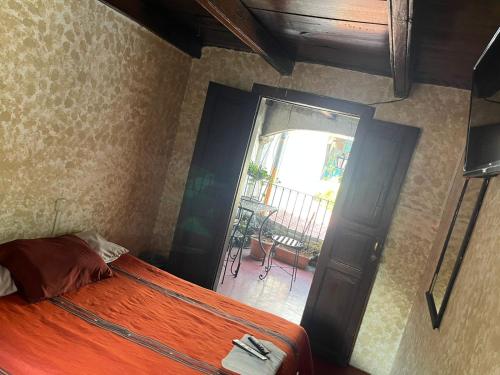 a bedroom with a bed and a door to a balcony at Cristales de Antigua Hotel Cristal in Antigua Guatemala