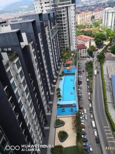 arial view of a city with a pool and buildings at Tom’s Homestay in Batu Caves