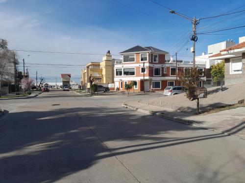 an empty street in a city with buildings at MAILAR d1 in Puerto Madryn