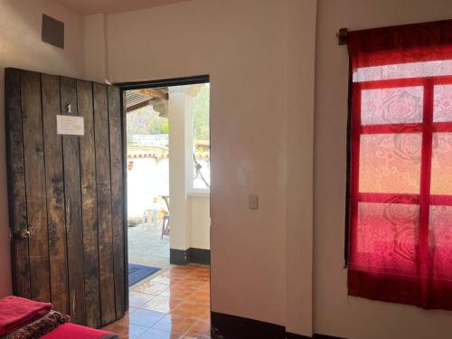 a room with a door and a red window at Cristales de Antigua Hotel Cristal in Antigua Guatemala