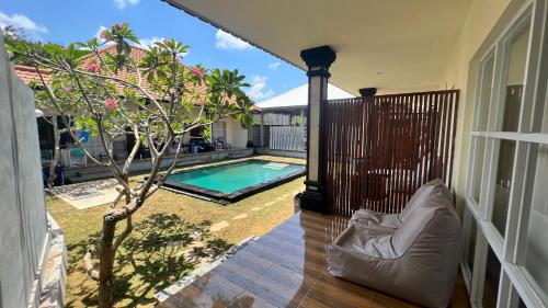 uma vista para uma piscina a partir de uma casa em LoTide Surf Camp Uluwatu em Uluwatu