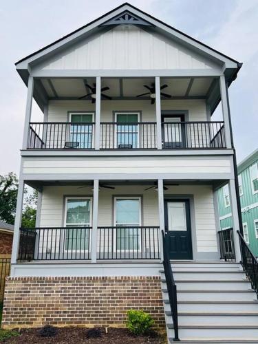 a large white house with a balcony on top at Luxury 4 Bedroom Home and private deck by MCG 6 in Augusta