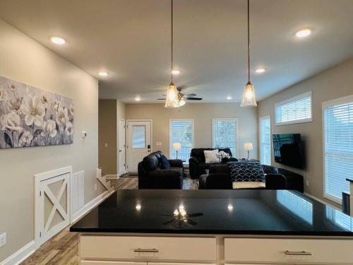 a living room with a couch and a table at Luxury 4 Bedroom Home and private deck by MCG 6 in Augusta