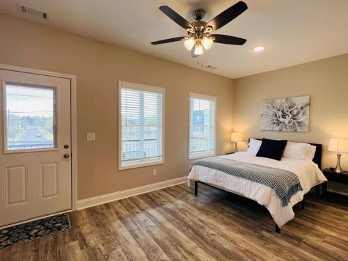 a bedroom with a bed and a ceiling fan at Luxury 4 Bedroom Home and private deck by MCG 6 in Augusta