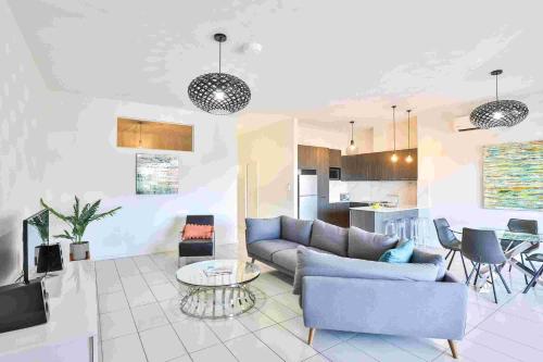 a living room with a couch and a table at Indulge Apartments - CBD in Mildura