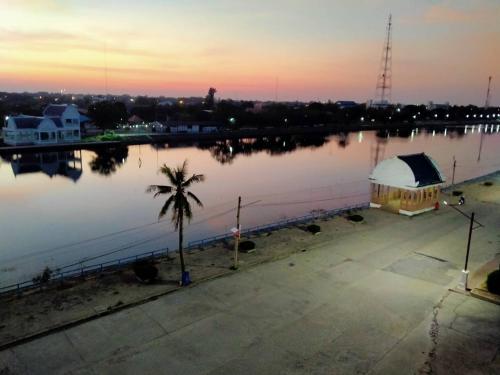 a view of a large body of water at sunset at Amatara Hotel in Pi Mai